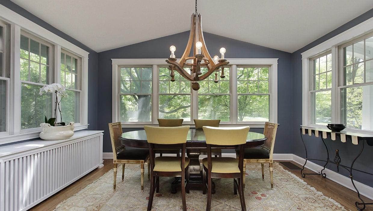 Vinyl-Hung-Complete1 A Dining Room With Single Hung Windows And A Table And Chairs.